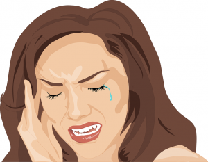 Woman crying holding her head because of a headache-cure-headache-naturally