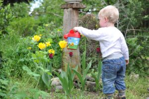 Organic Gardening For Kids-kid-watering-flowers